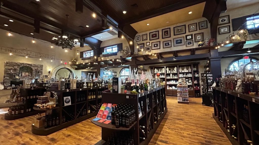 Interior of Childress Vineyards tasting room and gift shop with wine displays, decor, and warm lighting.