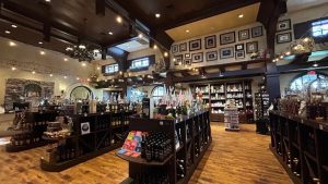 Interior of Childress Vineyards tasting room and gift shop with wine displays, decor, and warm lighting.