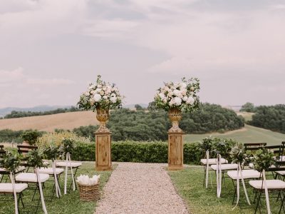 Scenic outdoor ceremony setup at one of the top wedding venues in Raleigh NC with floral arrangements and countryside views.