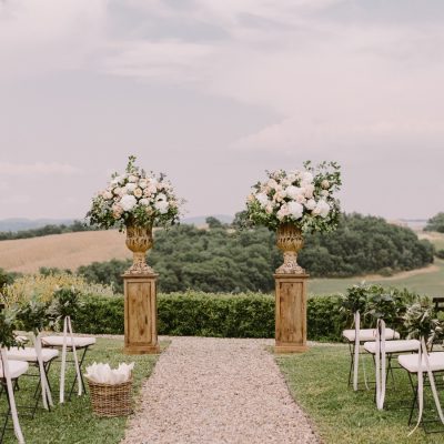 Scenic outdoor ceremony setup at one of the top wedding venues in Raleigh NC with floral arrangements and countryside views.