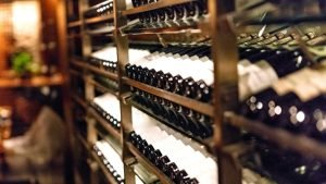 Wine bottles neatly stacked in racks inside a winery near Raleigh.