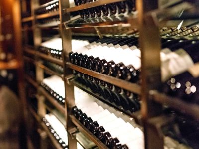 Wine bottles neatly stacked in racks inside a winery near Raleigh.