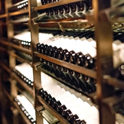 Wine bottles neatly stacked in racks inside a winery near Raleigh.